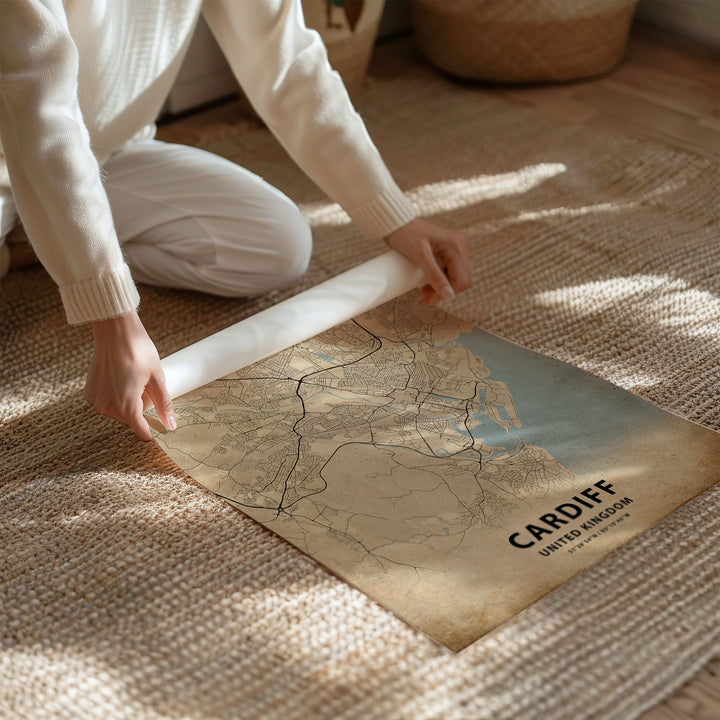 a person kneeling on the floor with a map on the floor