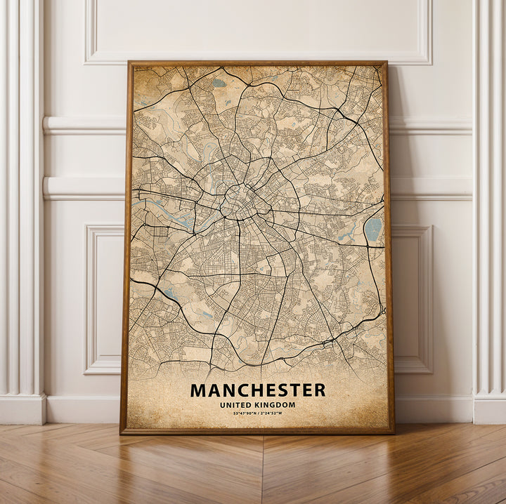 a framed map of manchester, england on a wooden floor