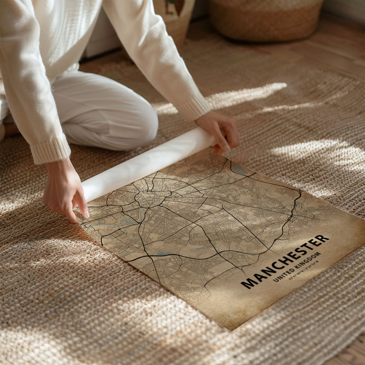 a person kneeling on the floor with a map on the floor