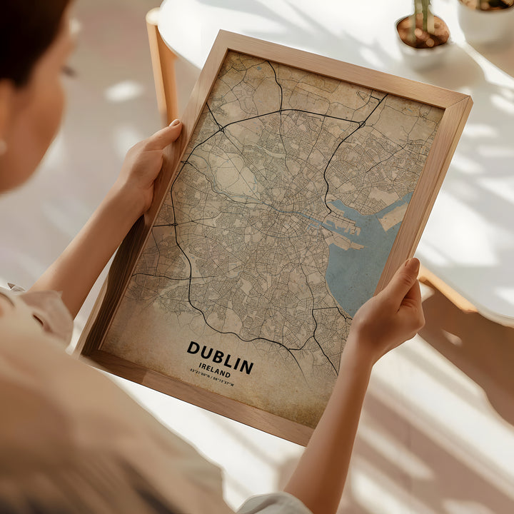 a woman holding a framed map of dublin