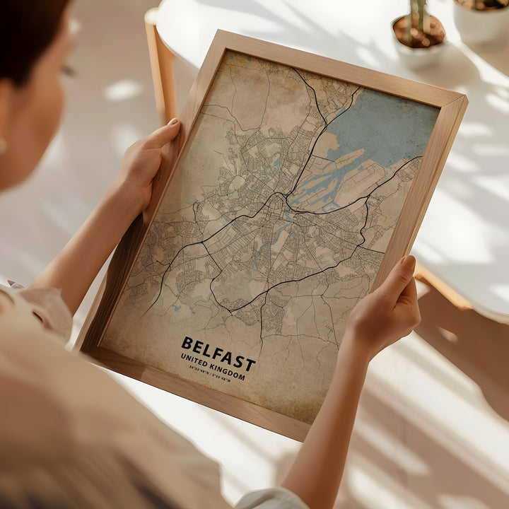 a woman holding a framed map of a city