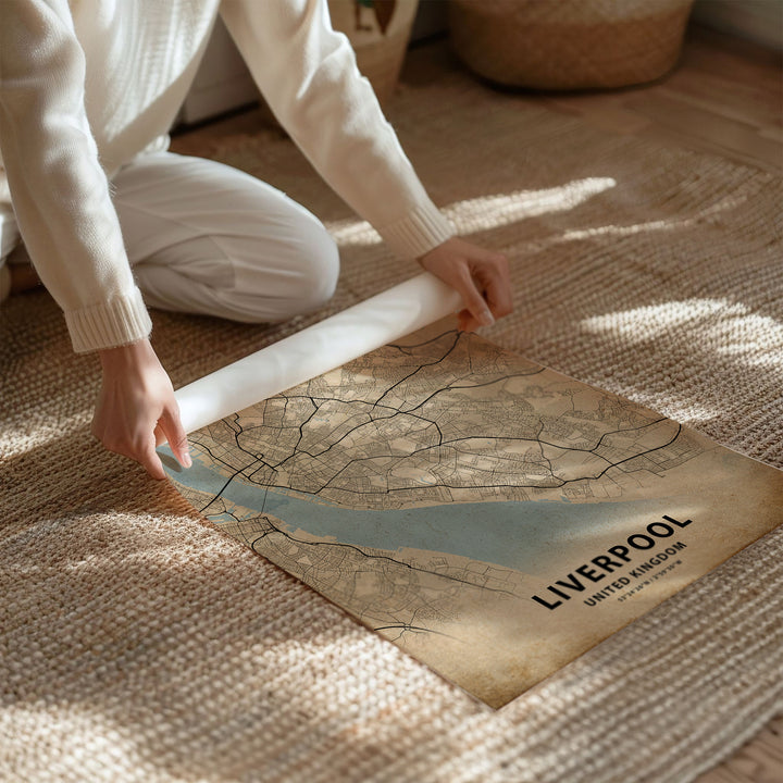 a person kneeling on the floor with a map on the floor