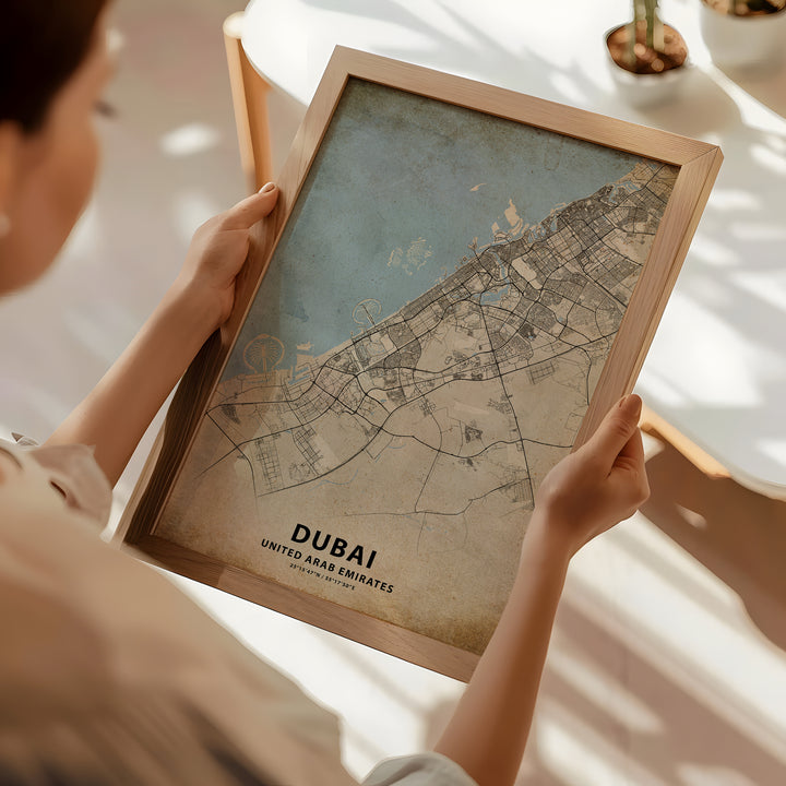 a woman holding a framed map of a city