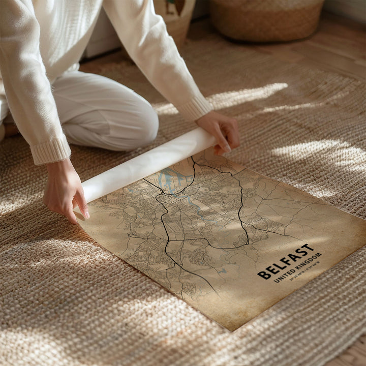 a person kneeling on the floor with a map on the floor