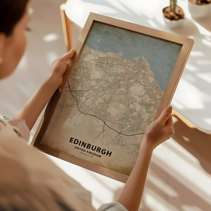 a woman holding a framed map of edinburgh