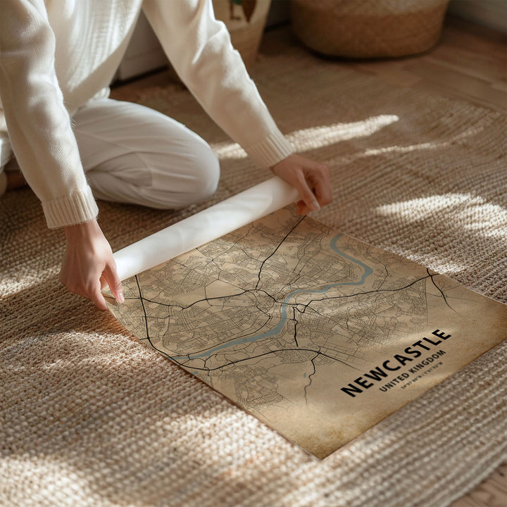 a person kneeling on the floor with a map on the floor